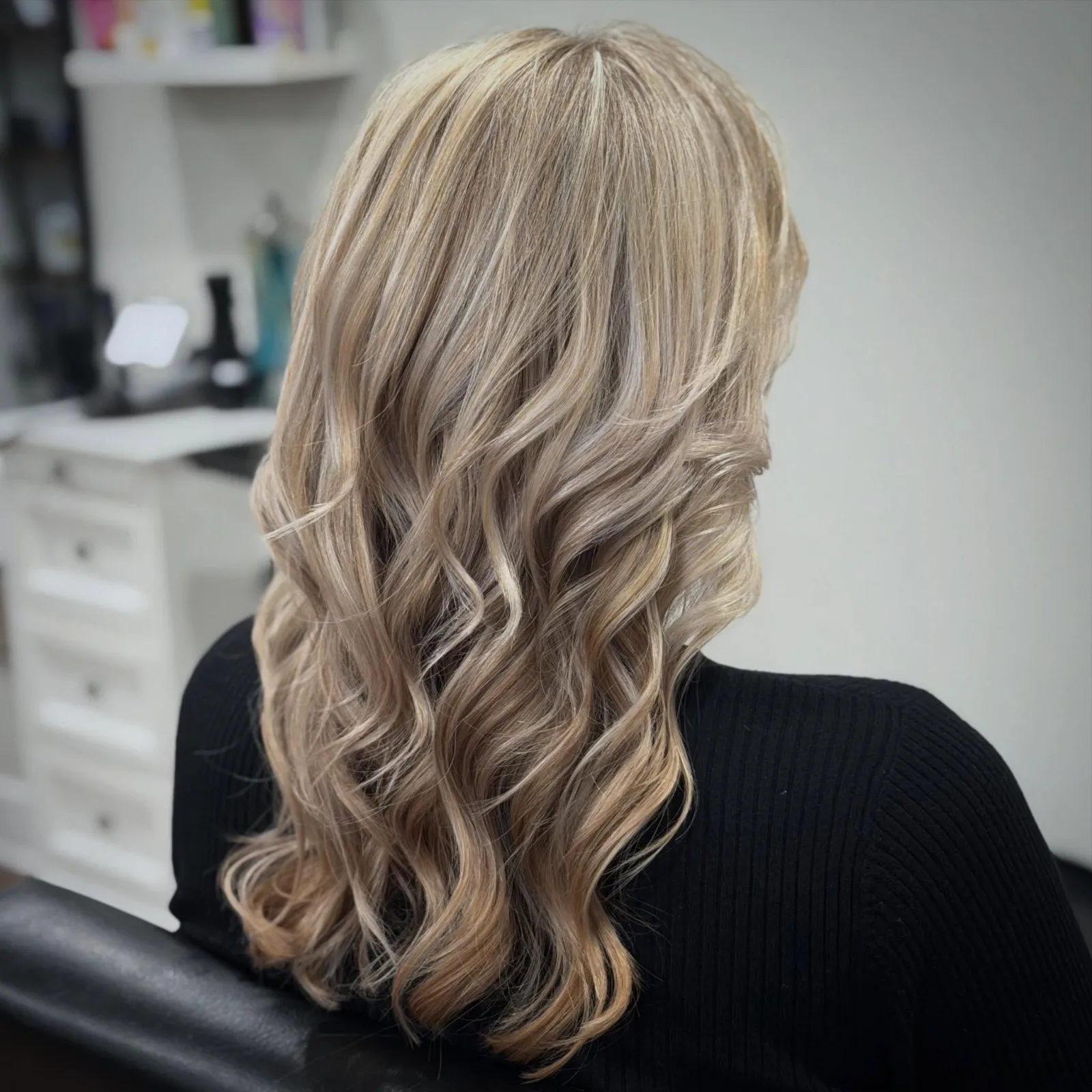 Long blonde hair with soft waves and dimensional highlights