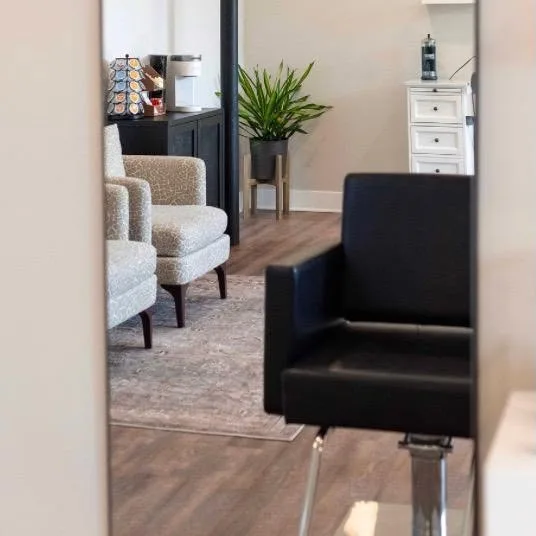 Upholstered armchairs in the salon’s waiting area